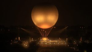 Olympic Cauldron floats in Paris night sky, Celine Dion performs